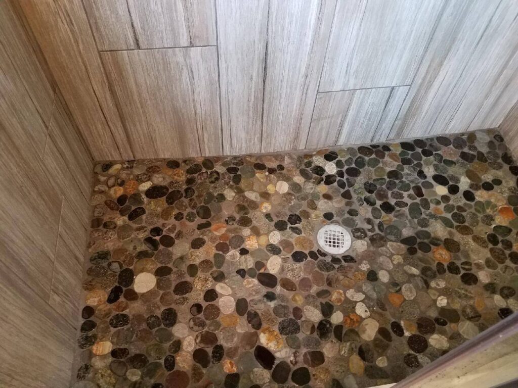 Picture of a finished shower stall showing the unusual floor tile pattern